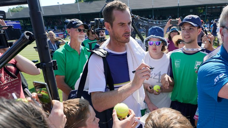 Andy Murray, of Britain, signs autographs after a first round win over Sam Querrey, of the United States, at the 2022 Infosys Hall of Fame Open, in Newport, R.I., Tuesday, July 12, 2022. (AP Photo/Steven Senne)