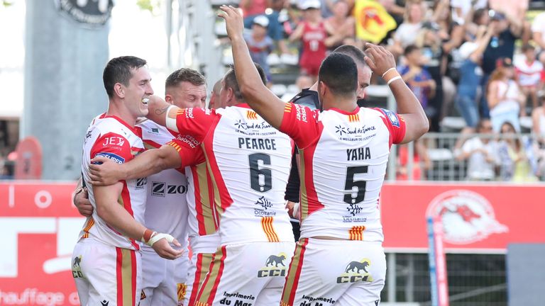 Picture by Manuel Blondeau/SWpix.com - 02/07/2022 - Rugby League - Betfred Super League Round 17 - Catalans Dragons v St Helens - Stade Gilbert Brutus, Perpignan, France - Josh..Drinkwater of Catalans Dragons celebrates with his teammates after scoring a try