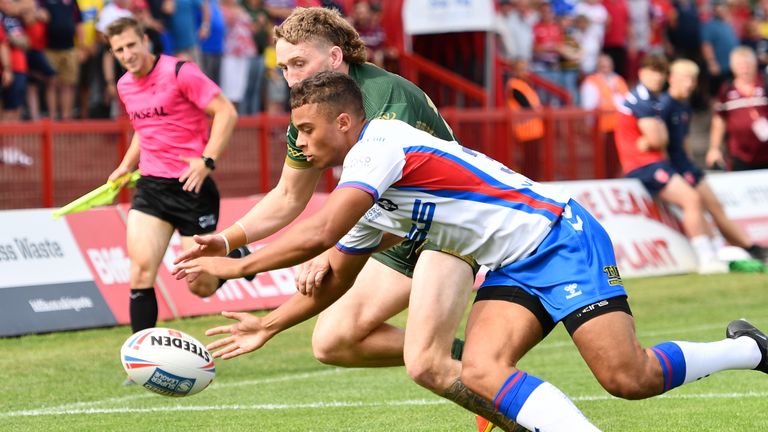 Corey Hall of Wakefield Trinity challenges Hull KR's Ethan Ryan