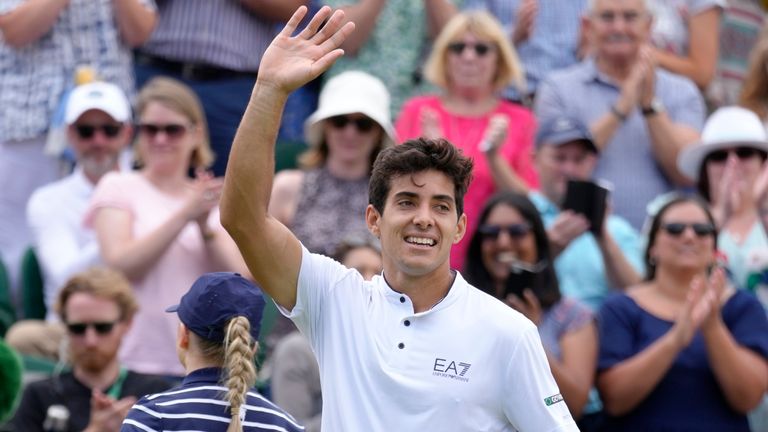 Chile's Cristian Garin celebrates after defeating Australia's Alex De Minaur during a men's singles fourth round match on day eight of the Wimbledon tennis championships in London, Monday, July 4, 2022. (AP Photo/Kirsty Wigglesworth)