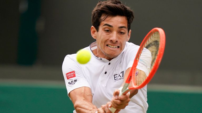 Chile's Cristian Garin returns the ball to Australia's Nick Kyrgios during a men's singles quarterfinal match on day ten of the Wimbledon tennis championships in London, Wednesday, July 6, 2022. (AP Photo/Alberto Pezzali)