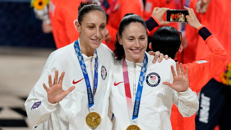 Diana Taurasi, left, and Sue Bird pose with their gold medals during the medal ceremony for women&#39;s basketball at the 2020 Tokro Olympics