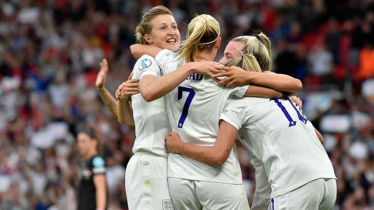 England's Beth Mead, center, celebrates with Ellen White, left, and Georgia Stanway after scoring the opening goal during the Women's Euro 2022 football match between England and Austria at Old Trafford in Manchester, England, on Wednesday July 6, 2022. (AP Photo/Rui Vieira)