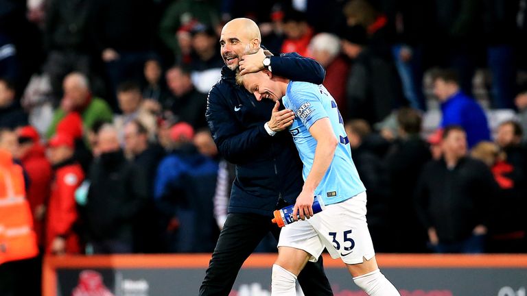 Manchester City boss Pep Guardiola celebrates full-time with Oleksandr Zinchenko during a Premier League match at Bournemouth's Vitality Stadium.