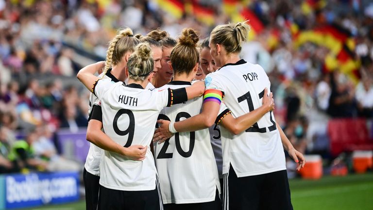 Germany&#39;s players crowd Lina Magull after her opener against Austria