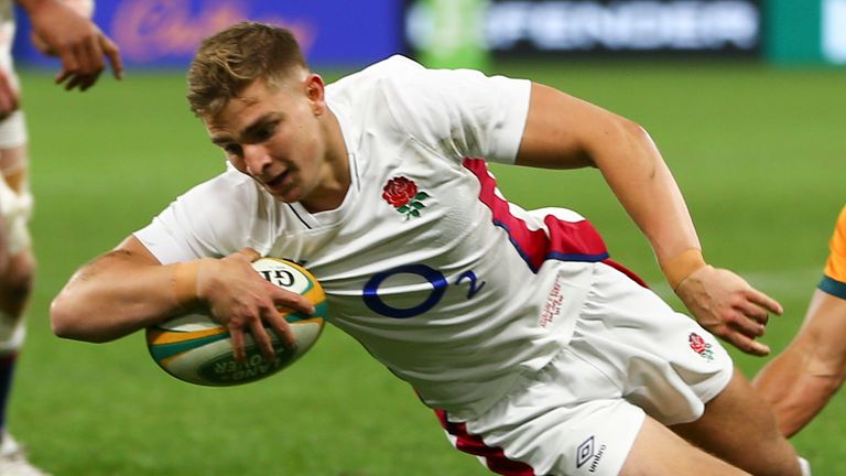 England's Jack van Poortlviet, left, is tackled by Australia's Jordan Petaia as he scores a try during the rugby international between England and the Wallabies in Perth, Australia, Saturday, July 2, 2022. (AP Photo/Gary Day)