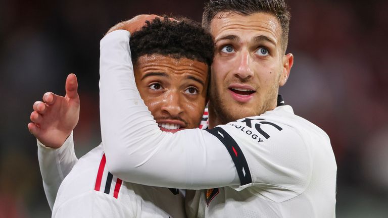 Jadon Sancho is congratulated by team-mate Diogo Dalot after making it 3-0
