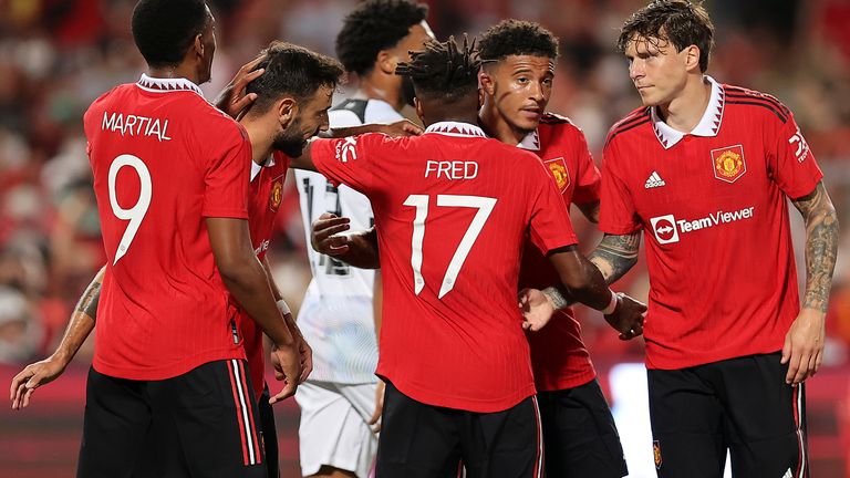 Jadon Sancho celebrates with his team-mates after scoring their first goal against Liverpool 