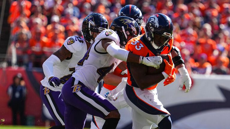 Denver Broncos running back Javonte Williams runs the ball against the Baltimore Ravens in the first half of an NFL football game