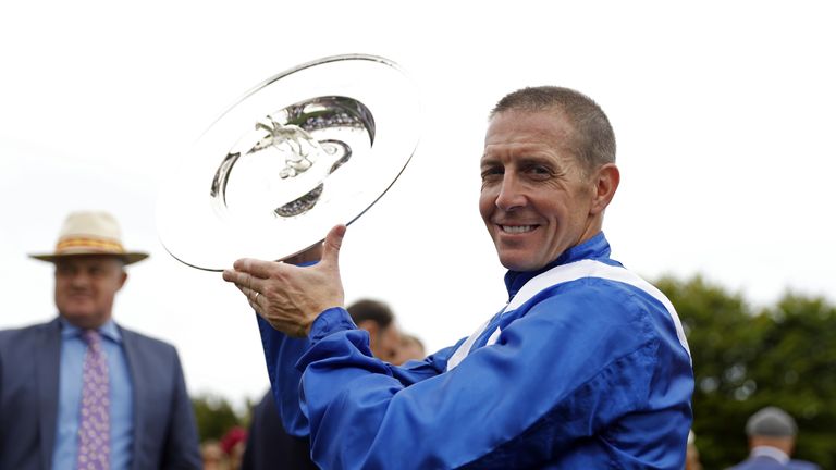 Jim Crowley lifts the Sussex Stakes trophy after victory over Baaeed
