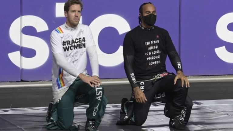 Sebastian Vettel takes a knee alongside Lewis Hamilton