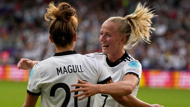 Lina Magull celebrates with Lea Schueller, right, after scoring the opening goal during the Women Euro 2022 group B soccer match between Germany and Denmark at Brentford Community Stadium in London, Friday, July 8, 2022. (AP Photo/Alessandra Tarantino)