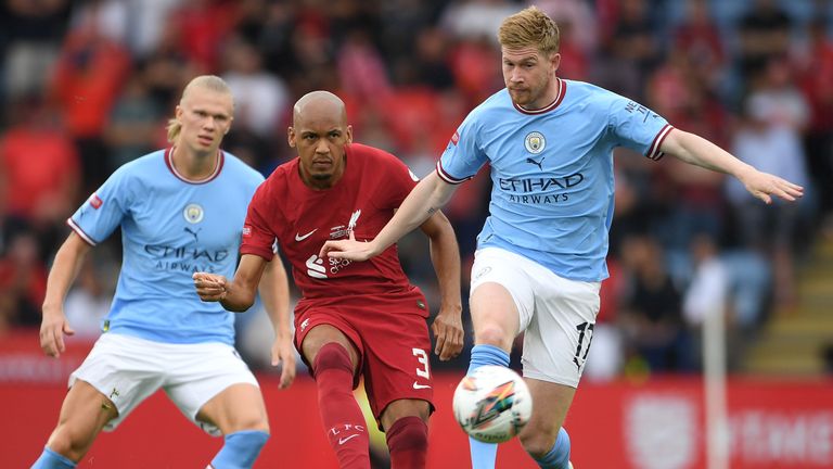 Fabinho is challenged by Erling Haaland and Kevin De Bruyne