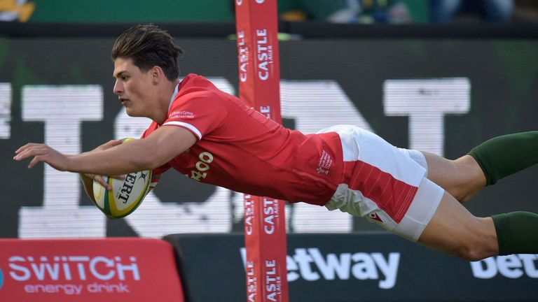 Wales' wing Louis Rees-Zammit dives to score the team's first try during an international rugby union match between South Africa and Wales at Loftus Versfeld in Pretoria
