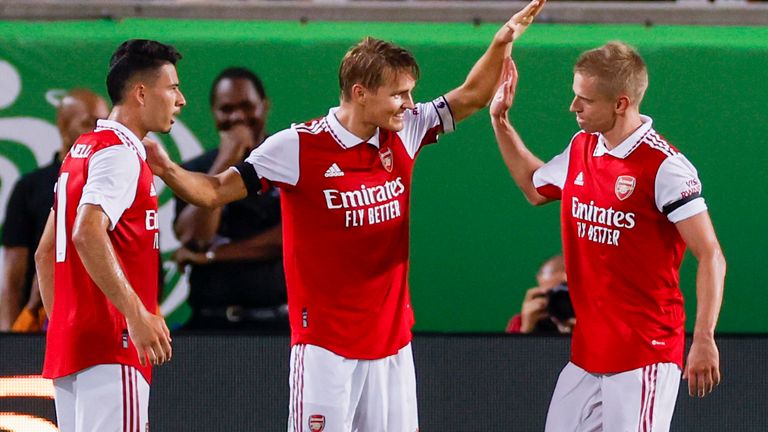 ORLANDO, FL - JULY 23: Arsenal midfielder Martin ..degaard (8) celebrates a goal with Arsenal forward Gabriel Martinelli (11) and Arsenal midfielder Oleksandr Zinchenko (35) during the game between Chelsea and Arsenal on July 23, 2022 at Camping World Stadium in Orlando, Fla.  (Photo by David Rosenblum/Icon Sportswire) (Icon Sportswire via AP Images)