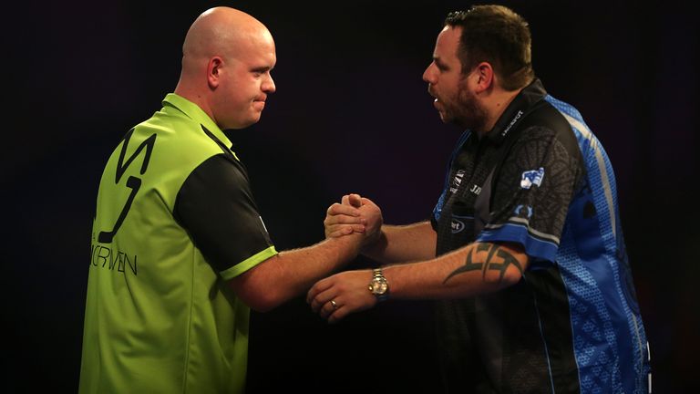Michael van Gerwen (left) celebrates winning against Adrian Lewis during day twelve of the William Hill World Darts Championships at Alexandra Palace, London.