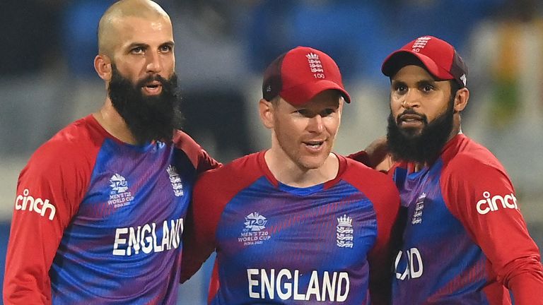 Moeen Ali (L) and Adil Rashid (R) are embraced by former England captain Eoin Morgan