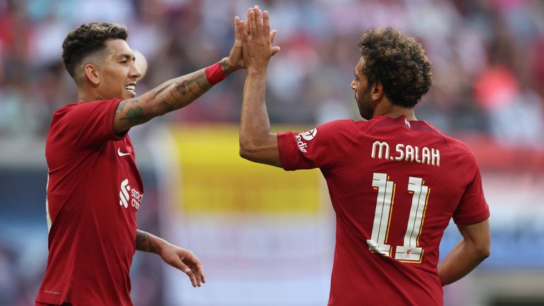 Liverpool's Mohamed Salah celebrates with Roberto Firmino after scoring against RB Leipzig