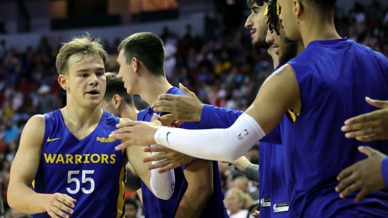 Mac McClung #55 of the Golden State Warriors is congratulated by teammates on the bench as he checks out of a game against the San Antonio Spurs during the 2022 NBA Summer League at the Thomas & Mack Center on July 10, 2022 in Las Vegas, Nevada.