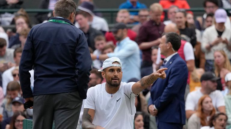 Australia's Nick Kyrgios talks to an official during a third round men's singles match against Greece's Stefanos Tsitsipas on day six of the Wimbledon tennis championships in London, Saturday, July 2, 2022. (AP Photo/Kirsty Wigglesworth)