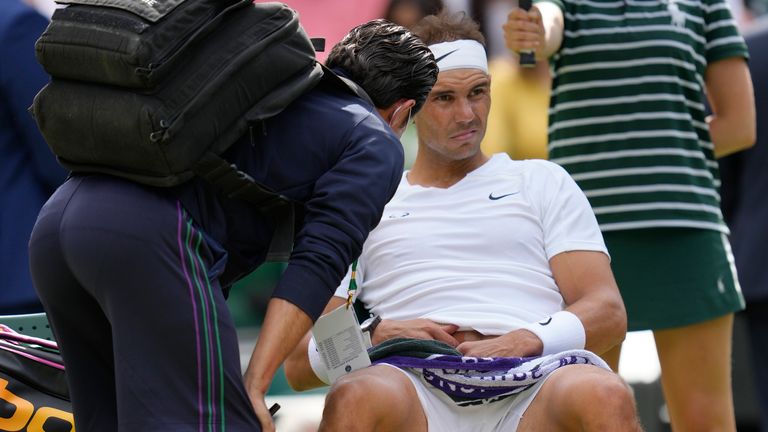 Spain's Rafael Nadal receives treatment just before a medical timeout as he plays Taylor Fritz of the US in a men's singles quarterfinal match on day ten of the Wimbledon tennis championships in London, Wednesday, July 6, 2022. (AP Photo/Kirsty Wigglesworth, File)