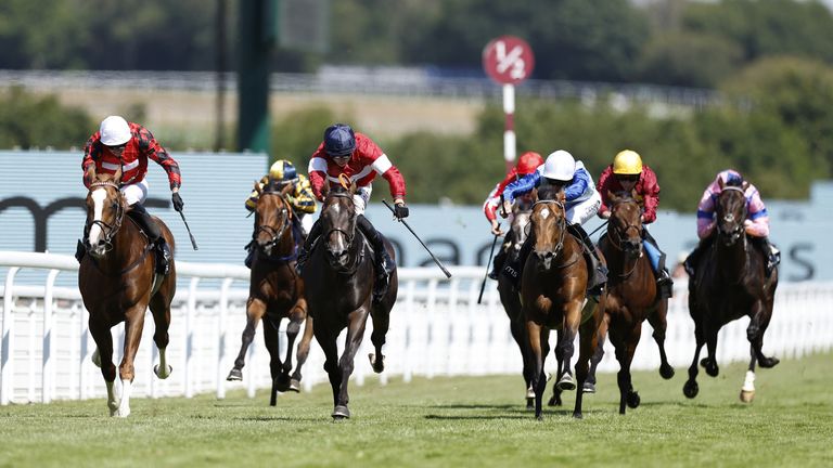 Rocchigiani and Tom Marquand (navy cap) beats The Wizard Of Eye to win at Goodwood