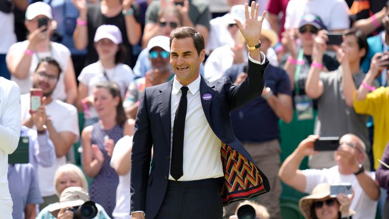 Switzerland&#39;s Roger Federer waves during a 100 years of Centre Court celebration on day seven of the Wimbledon tennis championships in London, Sunday, July 3, 2022. (AP Photo/Kirsty Wigglesworth)