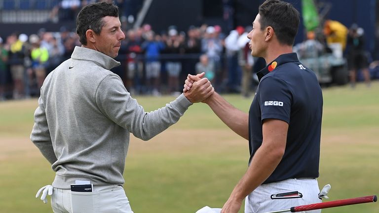 Northern Ireland's Rory McIlroy (L) and Norway's Viktor Hovland shake hands on the green of the 18th hole during Day Three of The 150th Open at St Andrews 