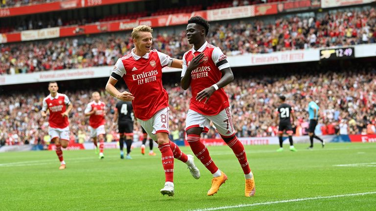 New Arsenal captain Martin Odegaard celebrates with Bukayo Saka against Sevilla