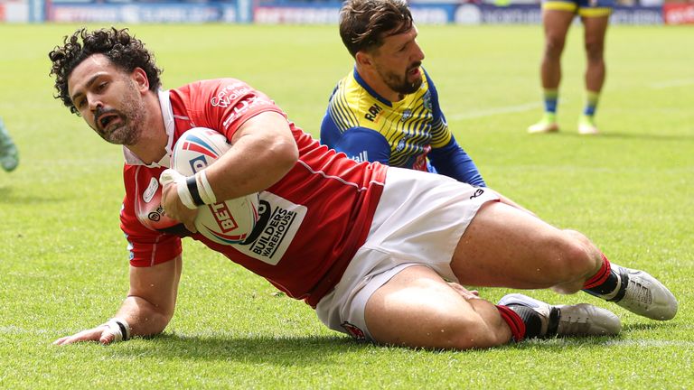 Salford Red Devils' Rhys Williams scores a try against Warrington