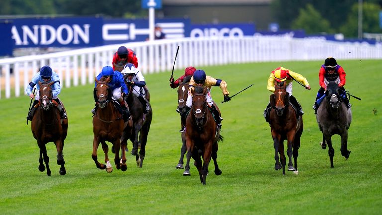 Tempus and Hollie Doyle (gold and navy) rise clearly to win at Ascot