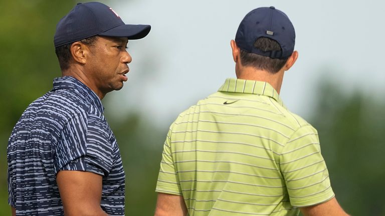 Tiger Woods and Rory McIlroy, of North Ireland, walks on the 13th hole during the first round of the PGA Championship golf tournament, Thursday, May 19, 2022, in Tulsa, Okla. (AP Photo/Matt York)