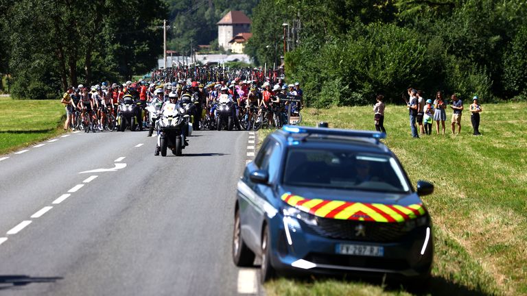 A view of the peloton stopped due to protesters blocking the route on Stage 10 of the Tour de France