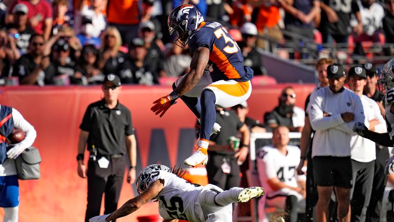 Denver Broncos running back Javonte Williams leaps over the tackle of Las Vegas Raiders free safety Trevon Moehrig