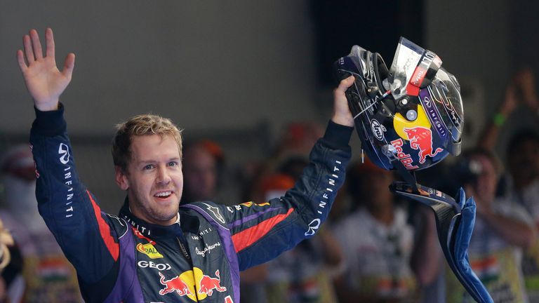 Red Bull driver Sebastian Vettel of Germany waves to the crowd after winning the Indian Formula One Grand Prix and his 4th straight F1 world drivers championship at the Buddh International Circuit in Noida, India, Sunday, Oct. 27, 2013. 