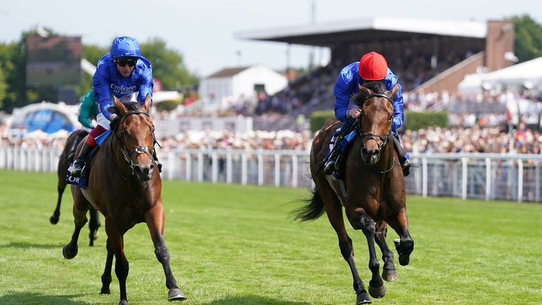 Warren Point (red cap) beats stablemate Blue Trail to win at Goodwood