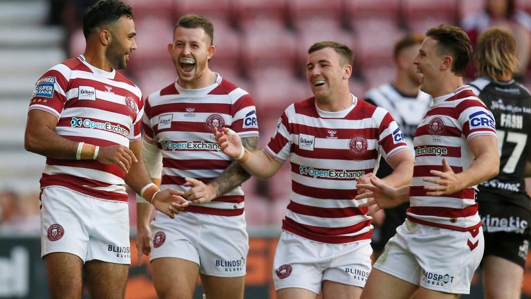 Picture by Ed Sykes/SWpix.com - 15/07/2022 - Rugby League - Betfred Super League Round 19 - Wigan Warriors v Hull FC - DW Stadium, Wigan, England - Wigan Warriors' Bevan French celebrates with team mates after scoring their sixth try and his fifth of the game