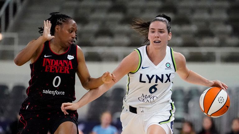 Minnesota Lynx forward Bridget Carleton (6) drives on Indiana Fever guard Kelsey Mitchell (0) in the second half of a WNBA basketball game in Indianapolis, Friday, July 15, 2022. The Lynx defeated the Fever 87-77. (AP Photo/Michael Conroy)