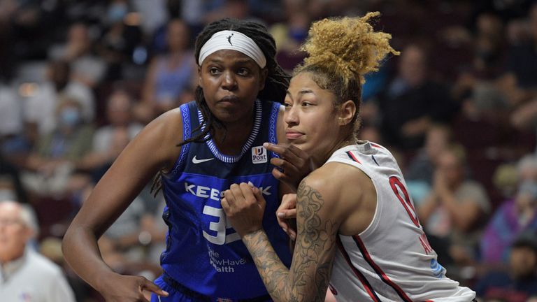 Connecticut Sun forward Jonquel Jones (35) and Washington Mystics center Shakira Austin (0) battle for position to get a potential rebound during a free throw in overtime of the WNBA game between the Washington Mystics and the Connecticut Sun on July 3, 2022, at Mohegan Sun Arena in Uncasville, CT.