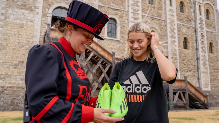 Alessia Russo hands over her boots to Yeoman Warder AJ Clark