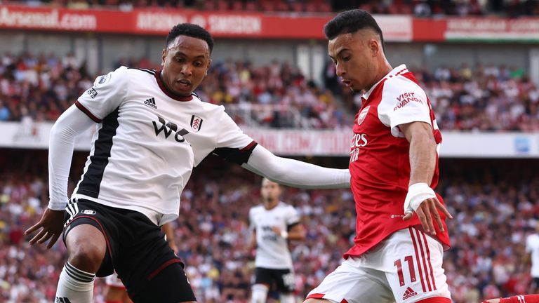 Gabriel Martinelli crosses while under pressure from Kenny Tete 