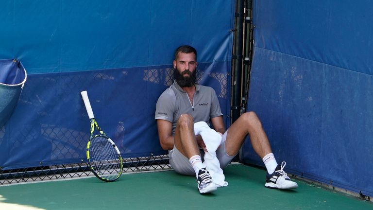 France's Benoit Paire sits on the court during a match against England's Cameron Norrie, as first responders attend a medical emergency in the stands at the men's singles first round match of the 2022 US Open at the Tennis Center USTA Billie Jean King National racket in New York, on August 30, 2022. (Photo by TIMOTHY A. CLARY/AFP) (Photo by TIMOTHY A. CLARY/AFP via Getty Images)
