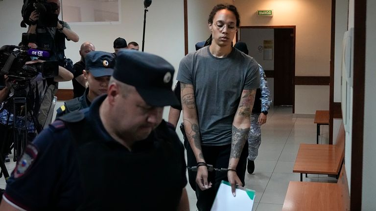 Griner is escorted in a court room prior to a hearing, in Khimki just outside Moscow, Russia