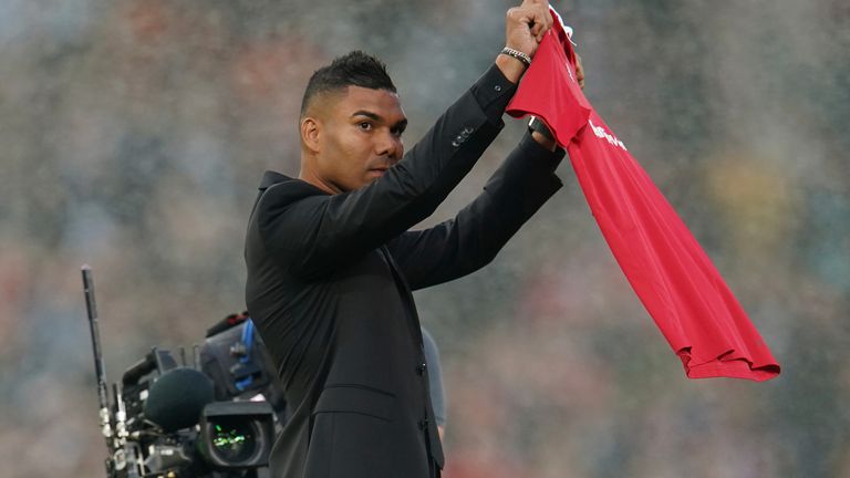 Manchester United's new player Casemiro holds his shirt