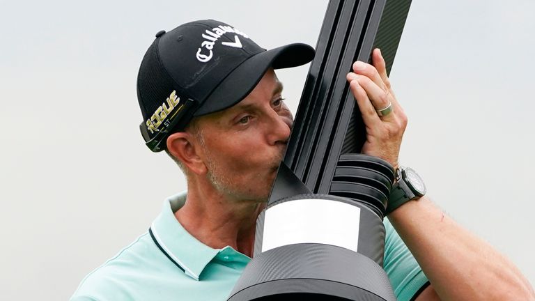 Henrik Stenson, of Sweden, kisses the trophy after winning the individual competition of the LIV Golf Invitational at Trump National in Bedminster, N.J., Sunday, July 31, 2022. (AP Photo/Seth Wenig)