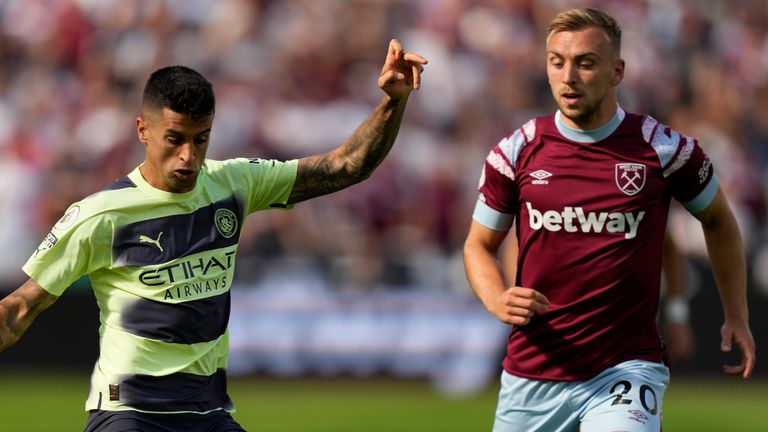 West Ham's Jarrod Bowen right, challenges Manchester City's Joao Cancelo