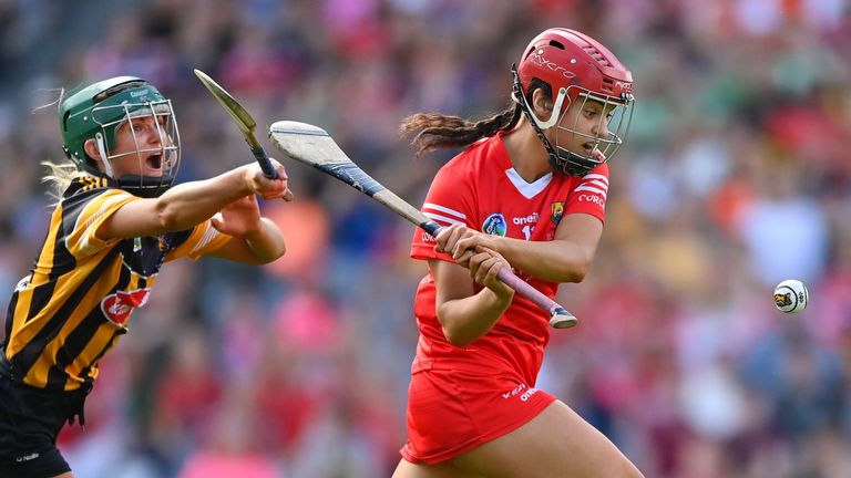 7 August 2022; Fiona Keating of Cork shoots to score her side's first goal, despite pressure from Kilkenny Michelle Teehan, during the Glen Dimplex All-Ireland Senior Camogie Championship Final match between Cork and Kilkenny at Croke Park in Dublin. Photo by Seb Daly/Sportsfile
