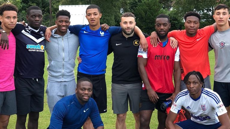 Kinetic Academy co-founder Harry Hudson poses with graduates including Myles Kenlock (top row, fourth from left), who joined Ipswich Town and Joe Aribo (bottom right)