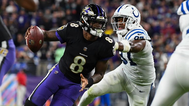 Baltimore Ravens quarterback Lamar Jackson runs the ball against Indianapolis Colts defensive end Al-Quadin Muhammad