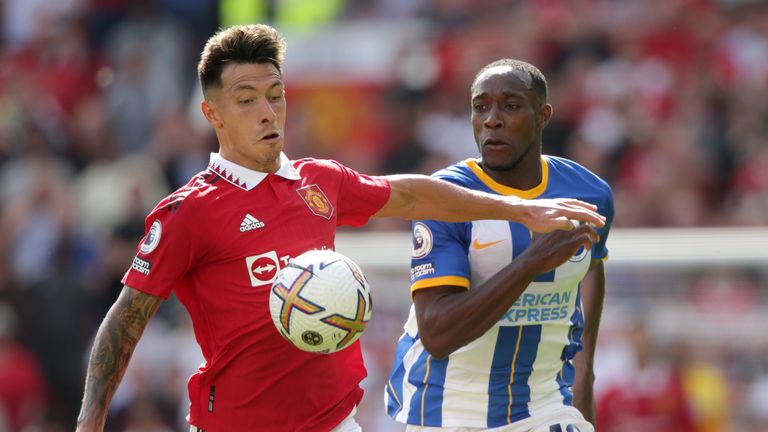 Manchester United's Lisandro Martinez competes with Brighton's Danny Welbeck